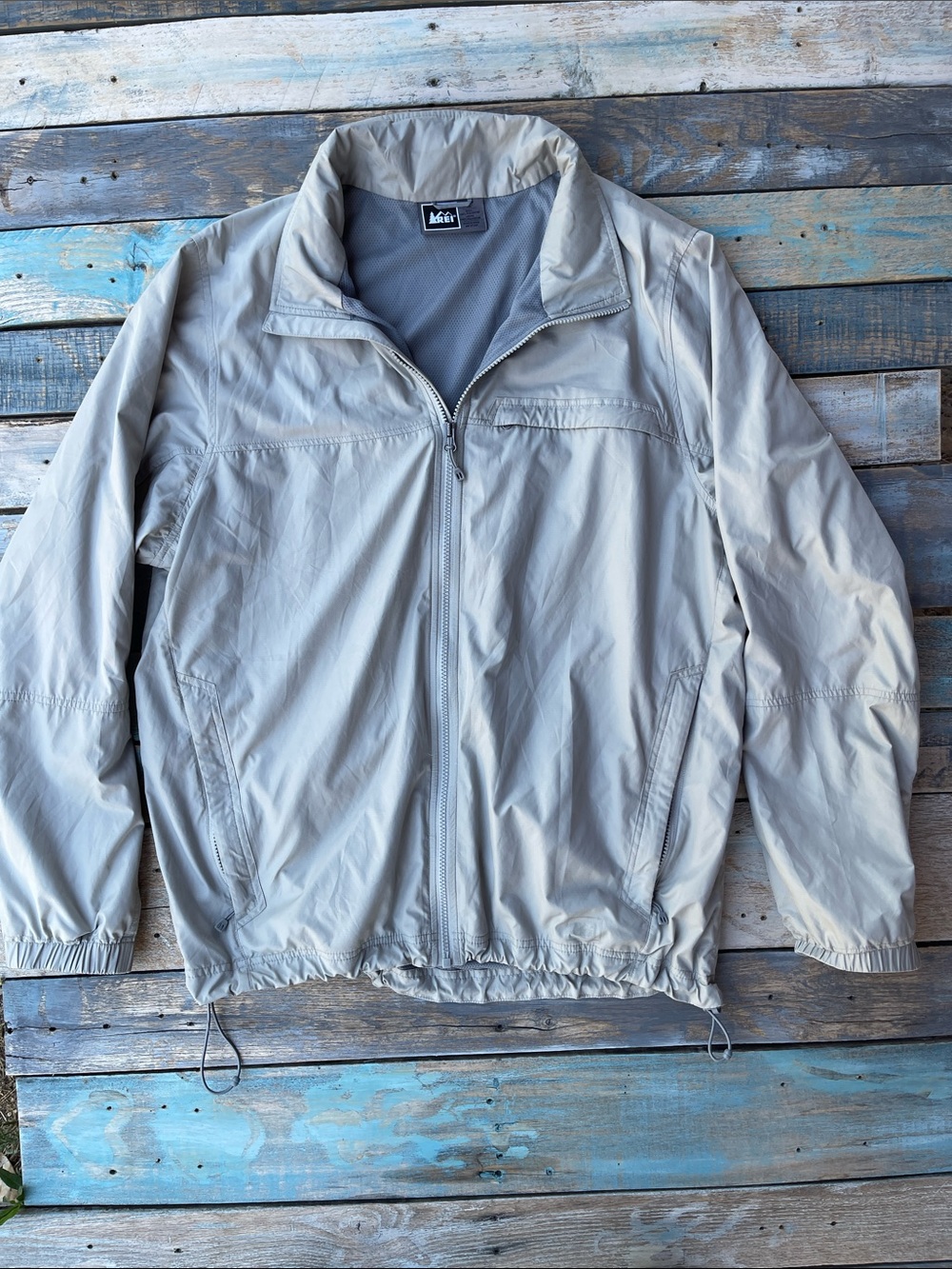 REI Co-op Trail Light Jacket Mens XL Beige Tan Windbreaker Stowable Hidden Hood